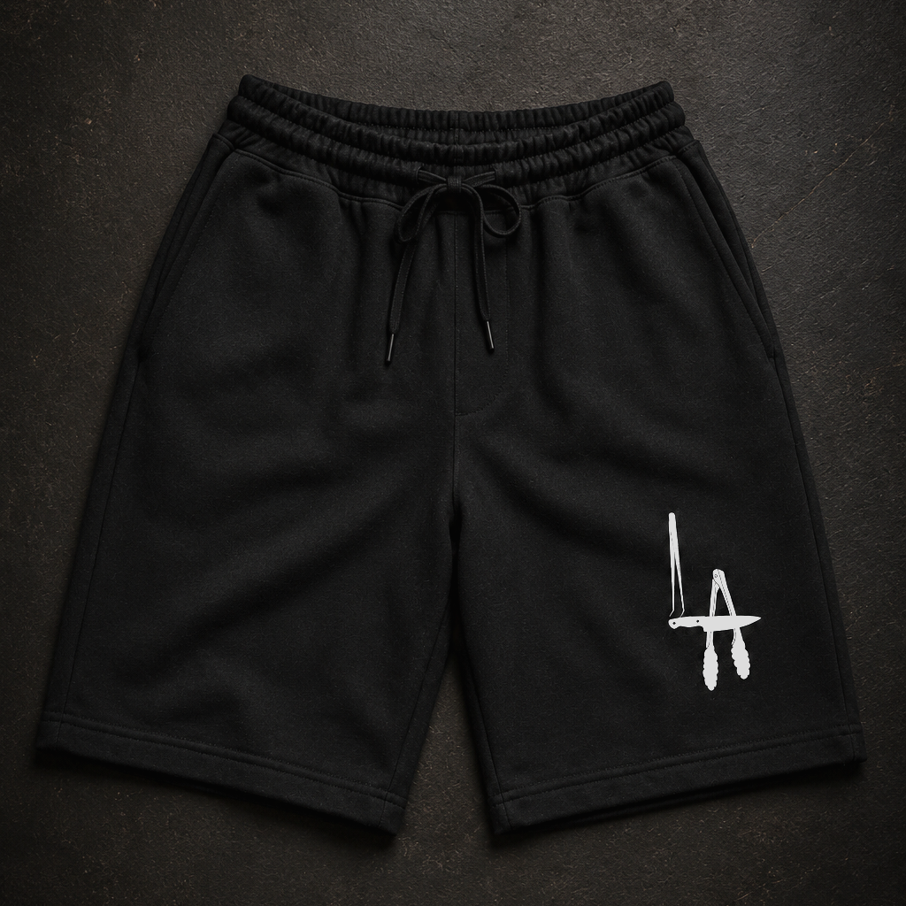 Black shorts with a white logo on a dark textured background