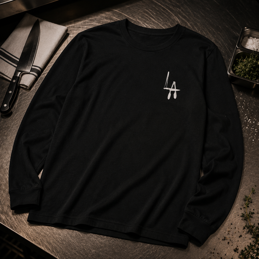 Black long-sleeve shirt with a logo on a kitchen counter