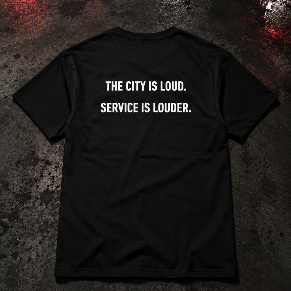 Black t-shirt with white text on a dark, reflective surface